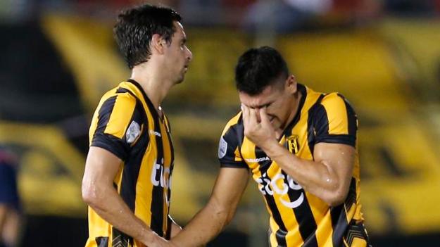 Rodrigo Lopez, left, and teammate Juan Patino, of Paraguay's Guarani, react after failing to classify for the next round, at the end of a Copa Libertadores soccer game with Ecuador's Independiente del Valle in Asuncion, Paraguay, Thursday, Feb. 11, 2016. (AP Photo/Jorge Saenz)